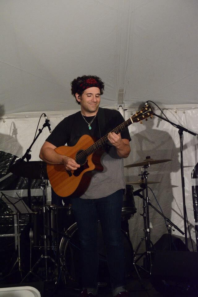Musician with a guitar on stage