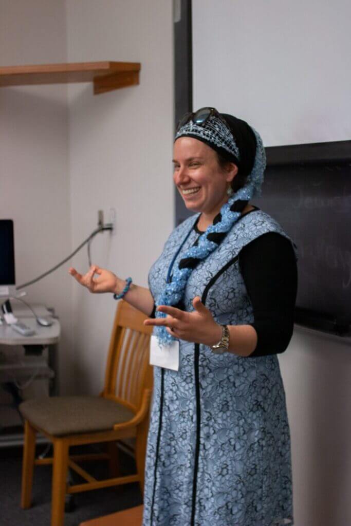 Woman in a headscarf speaking to a group