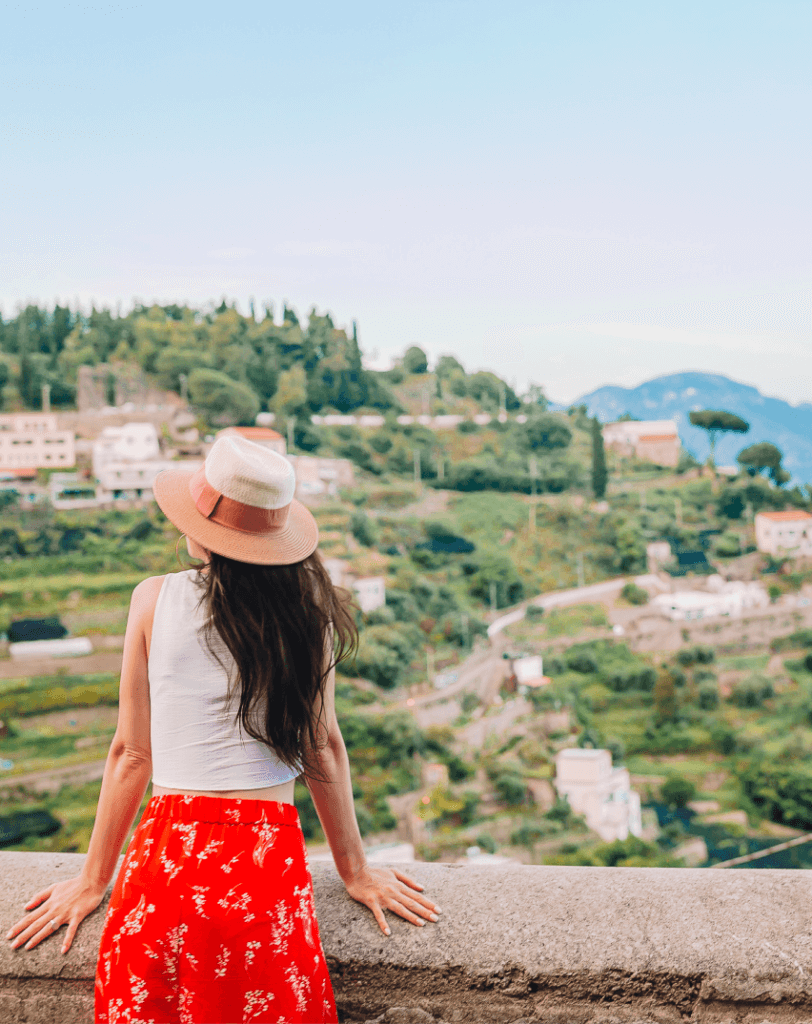 Woman in a sun hat overlooking a hillside town