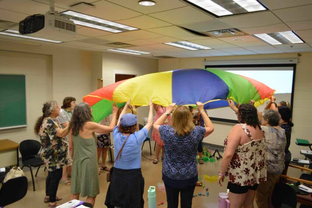 NewCAJE17 participants with a rainbow parachute