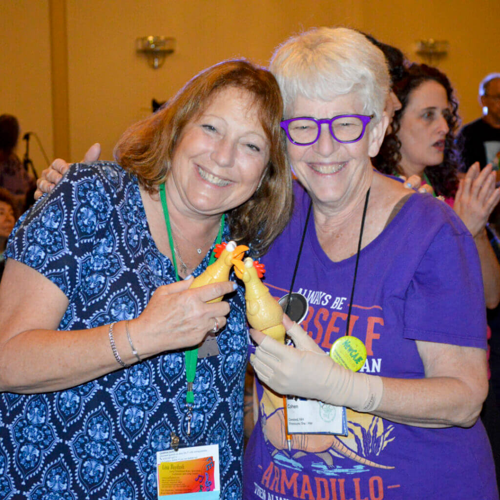 Two women laughing together at NewCAJE