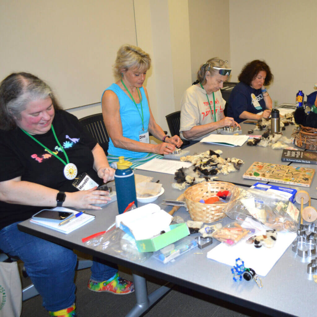 Teachers doing hands-on activities at a workshop table