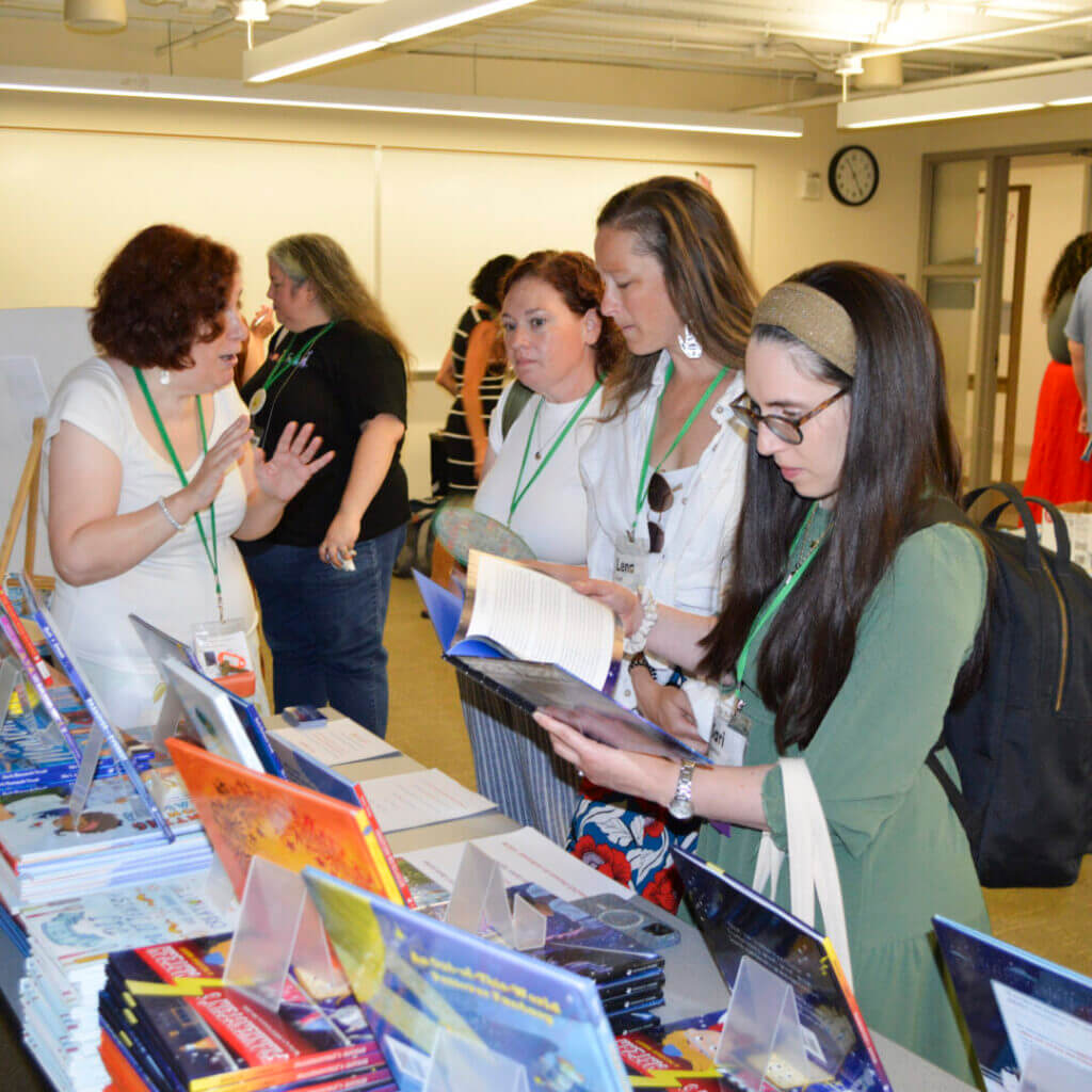 Educators working on crafts at a crowded table