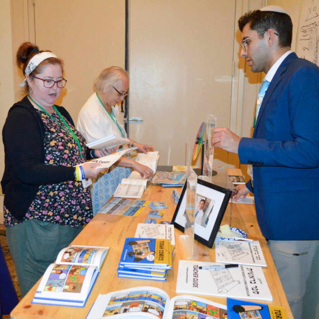 Educators talking at a resource table